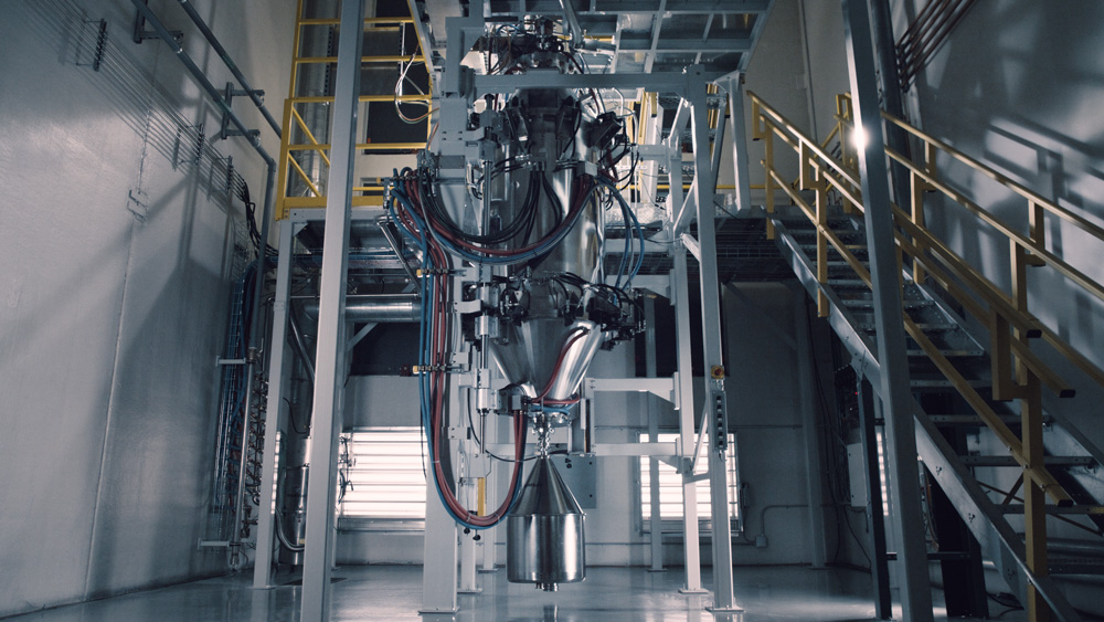 A large, tall, cylindrical machine in a clean lab